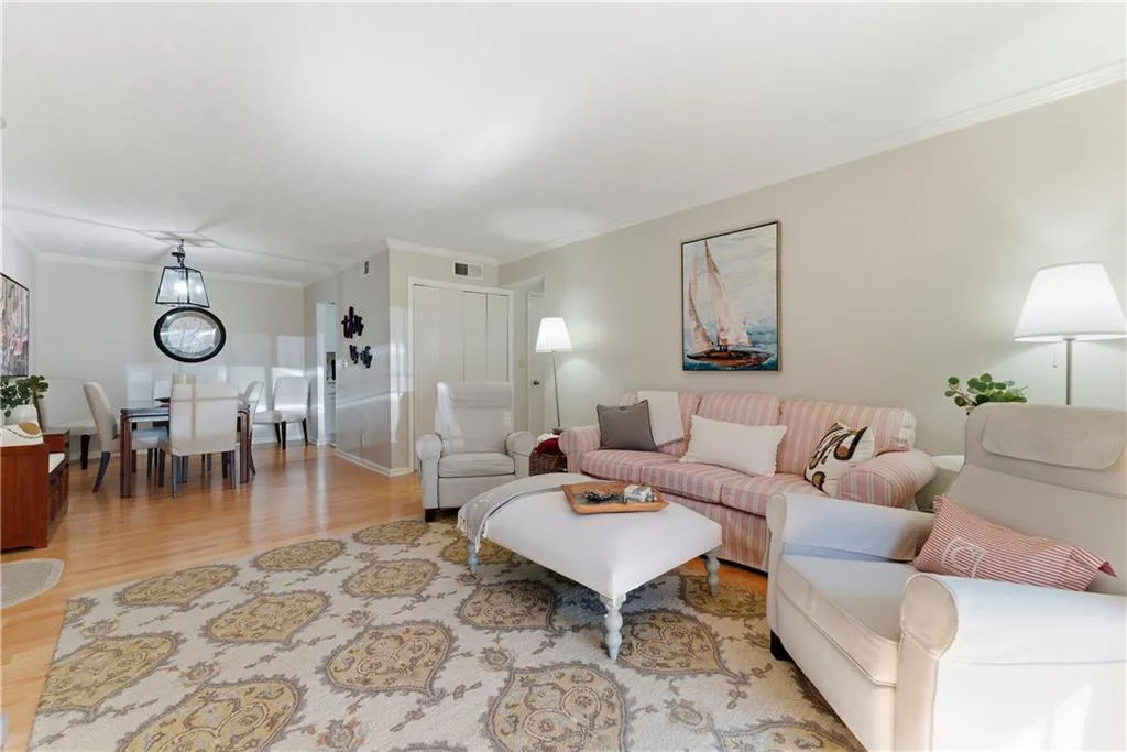 Living room featuring light wood finished floors and ornamental molding