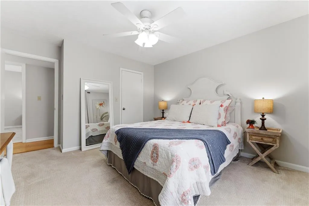 Bedroom featuring light colored carpet and ceiling fan