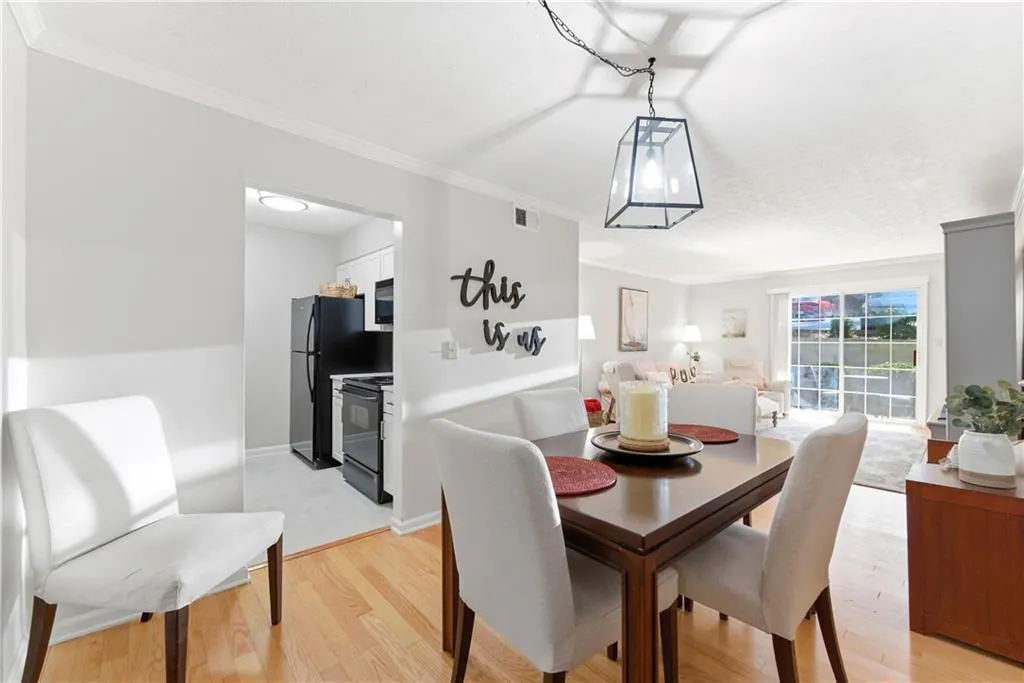 Dining room featuring crown molding and light wood-style floors