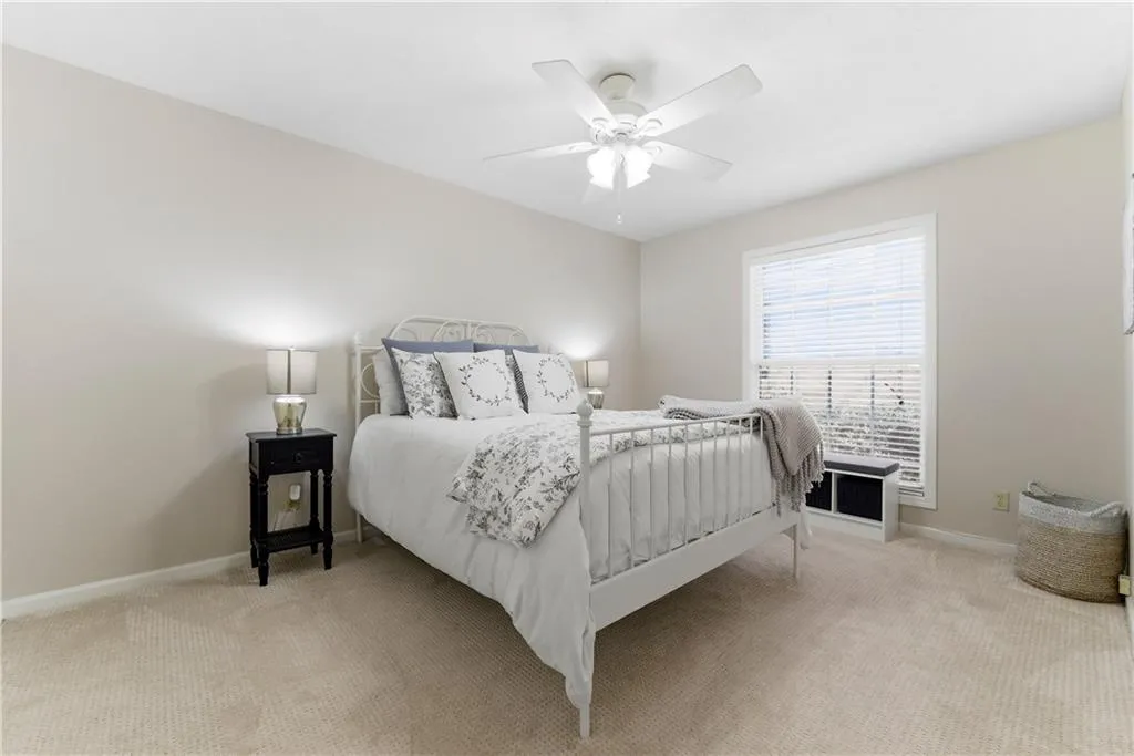 Bedroom featuring light carpet and a ceiling fan