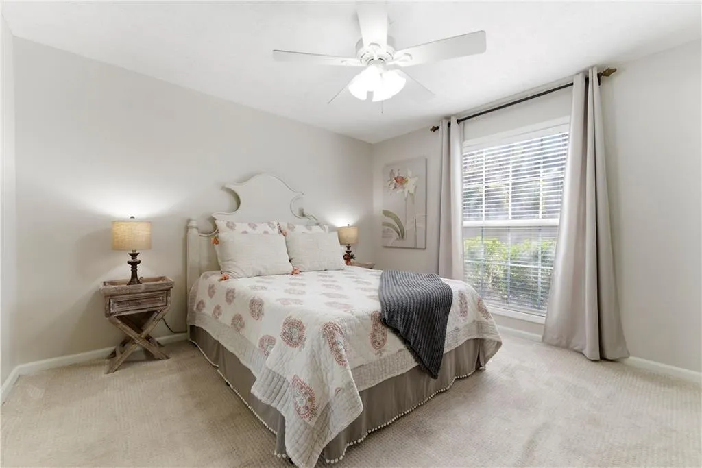 Bedroom featuring light carpet and a ceiling fan