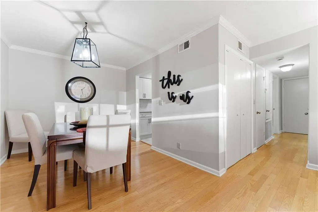 Dining space with ornamental molding and light wood finished floors