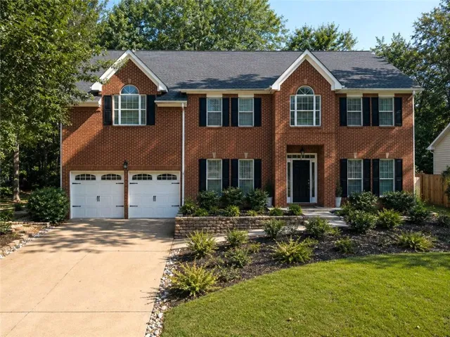 Brick exterior with a gabled roof and white trim