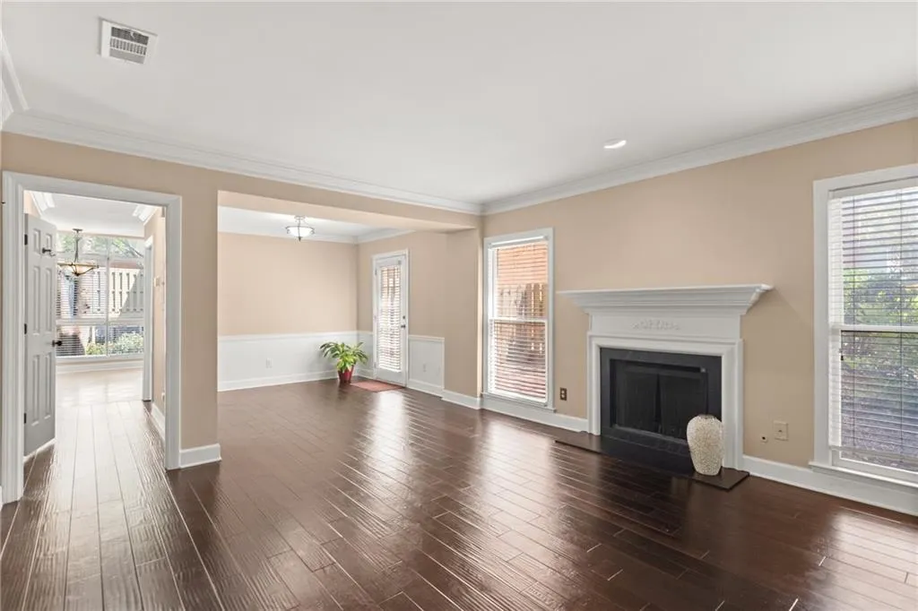 As soon as you walk in, you are welcomed by a wide, sun-lit living room with ornamental molding