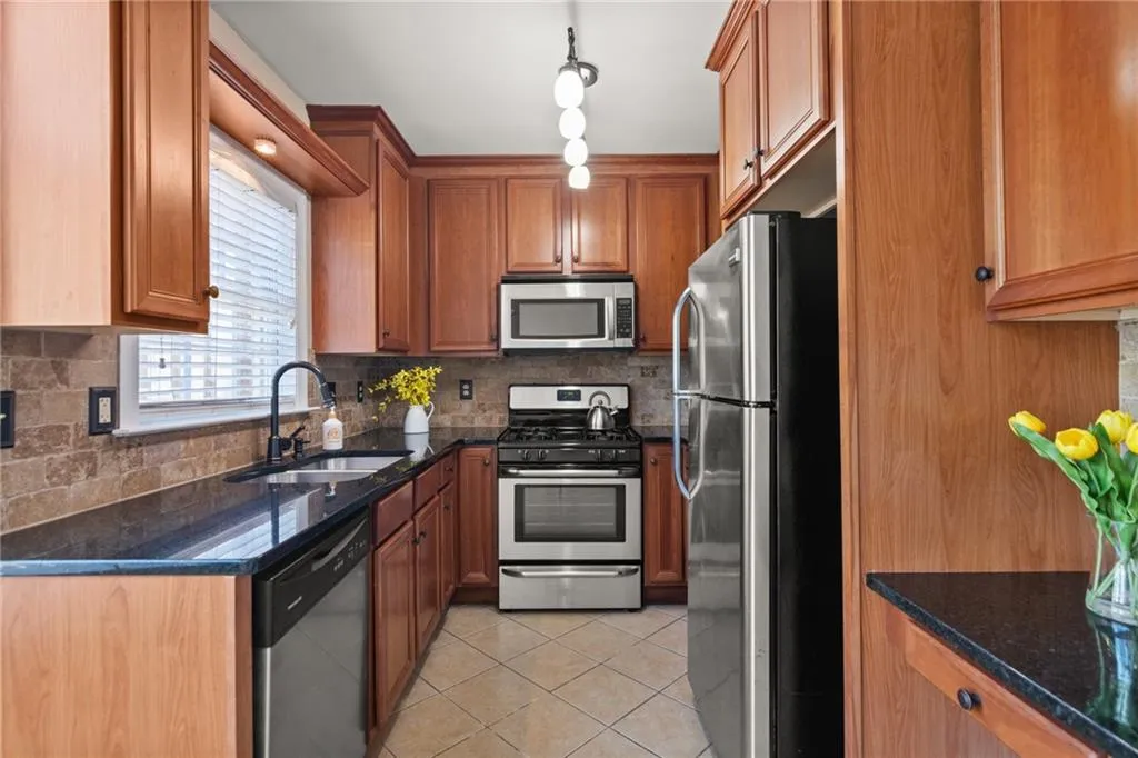 A look into your fully-equipped kitchen boasting modern stainless-steel appliances and natural light to make cooking fun and easy!