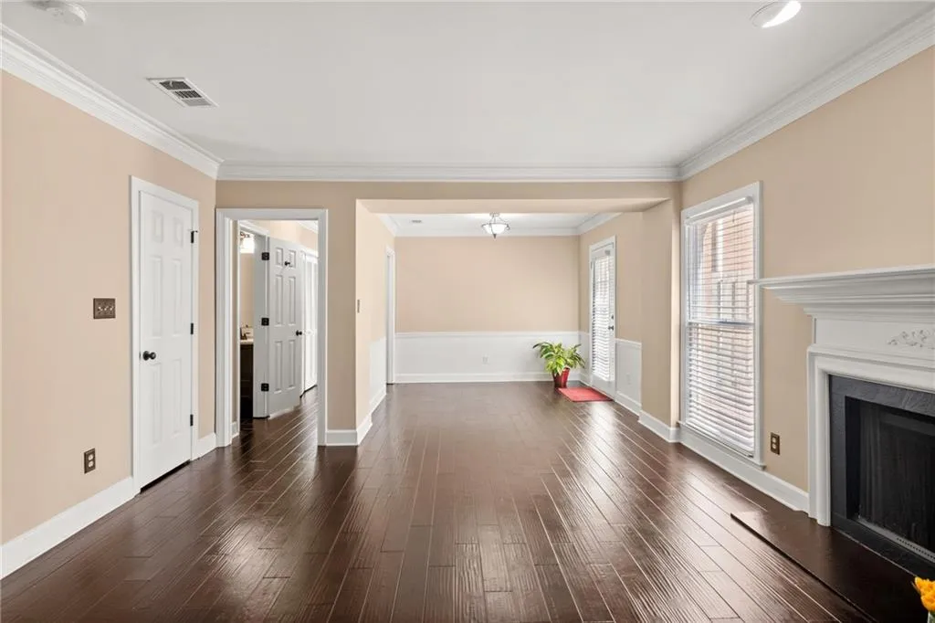 Entry way to the kitchen and peak into powder room and private patio to the right.