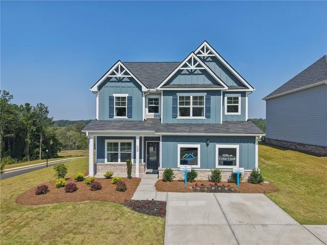 Two-story residential structure with blue siding, white trim, and a dark shingle roof