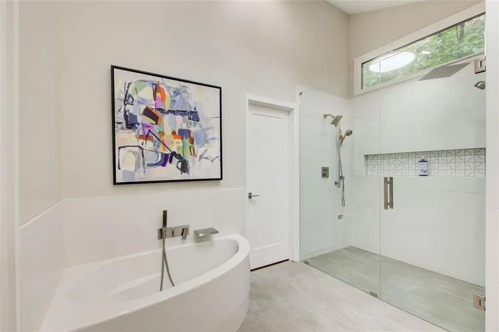 Curbless entry glass shower with luxury large format tiles and linear drain
