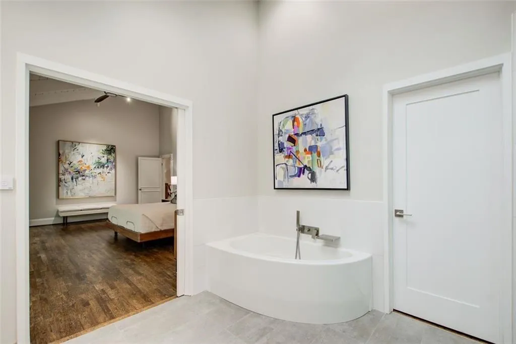 Artfully blended curved corner soaking tub in this spa like bathroom