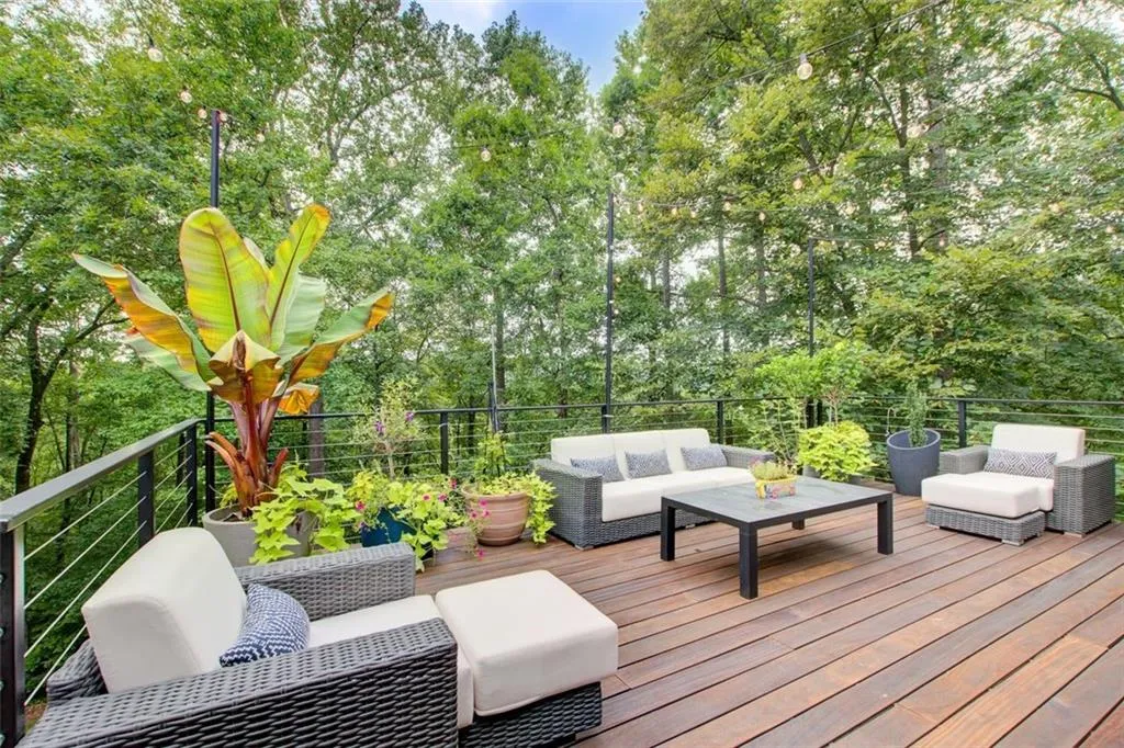 An expansive 750 square foot deck flows from the family room to the primary  suite