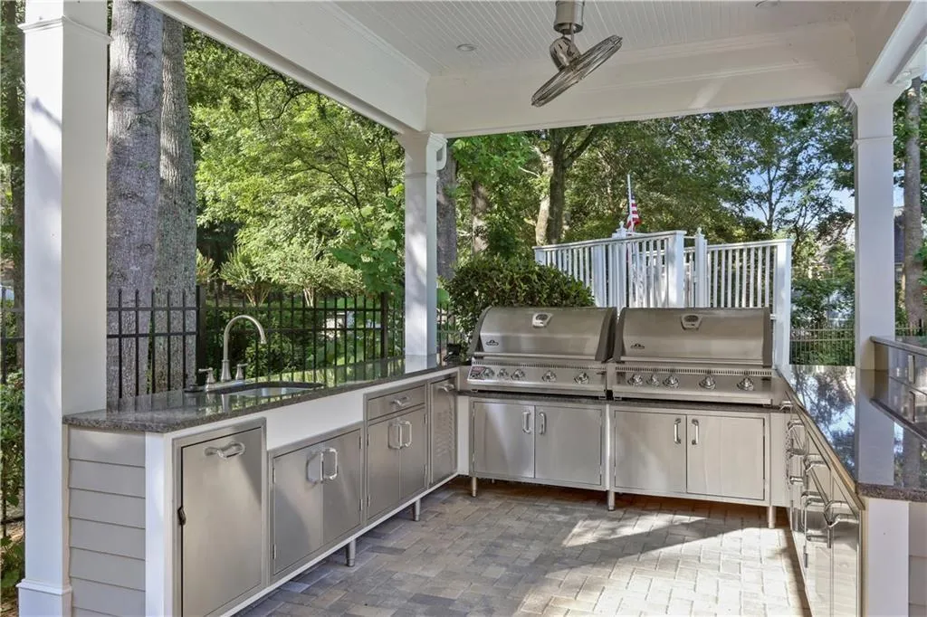 View of patio with an outdoor kitchen and ceiling fan