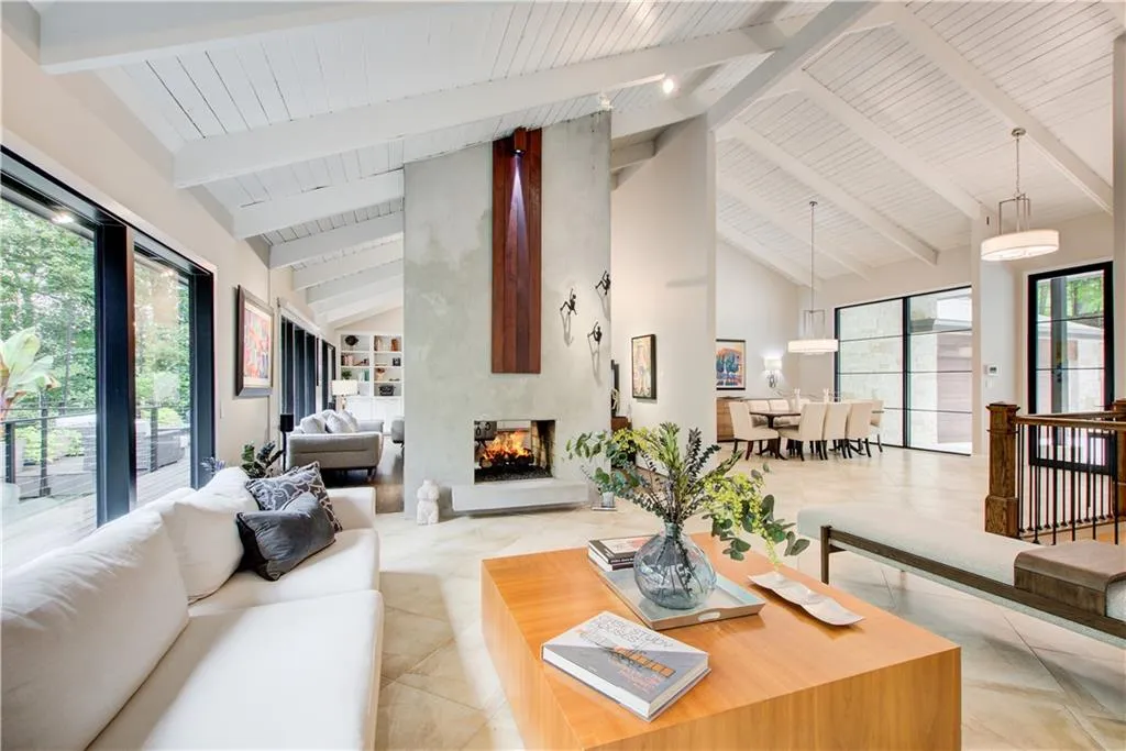 Living room with high vaulted ceiling, a premium fireplace, and a wood ceiling with exposed beams