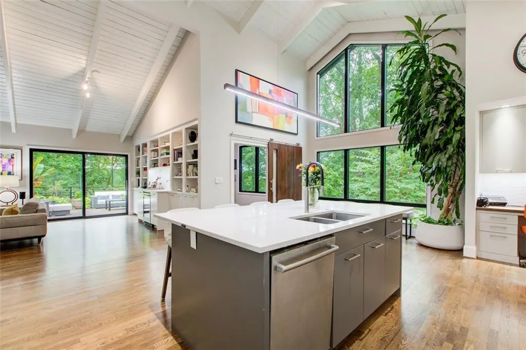 8 x 5 quartz island with storage, Bosch diswasher  and  keeping room has built in bookcases with integrated wet bar and wine refrigerator.
