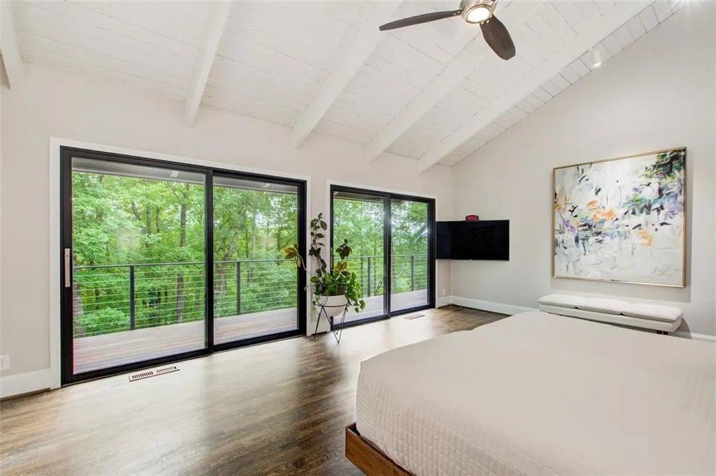 Spacious primary suite with wall of beautiful windows