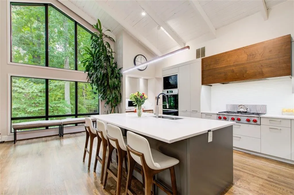 Chef's kitchen with custom hood, Dacor ovens and gas cooktop. Custom hood