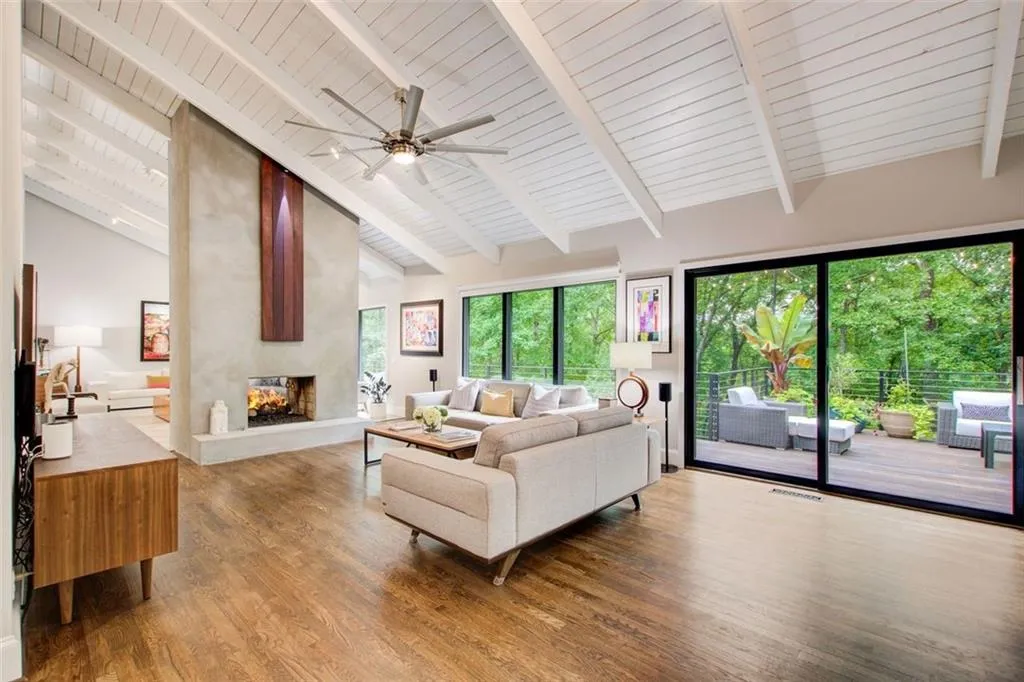 Double sided fireplace in this keeping room which opens to the kitchen and the perfect deck.