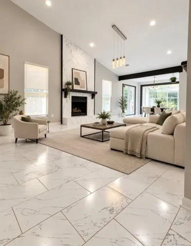 Vaulted ceiling with recessed lighting, tile flooring, marble-finish fireplace with mantel, and large windows