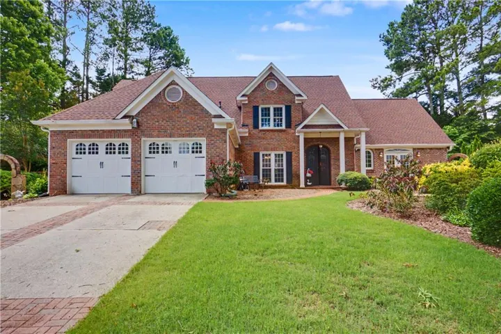 Brick front with custom brick accented driveway