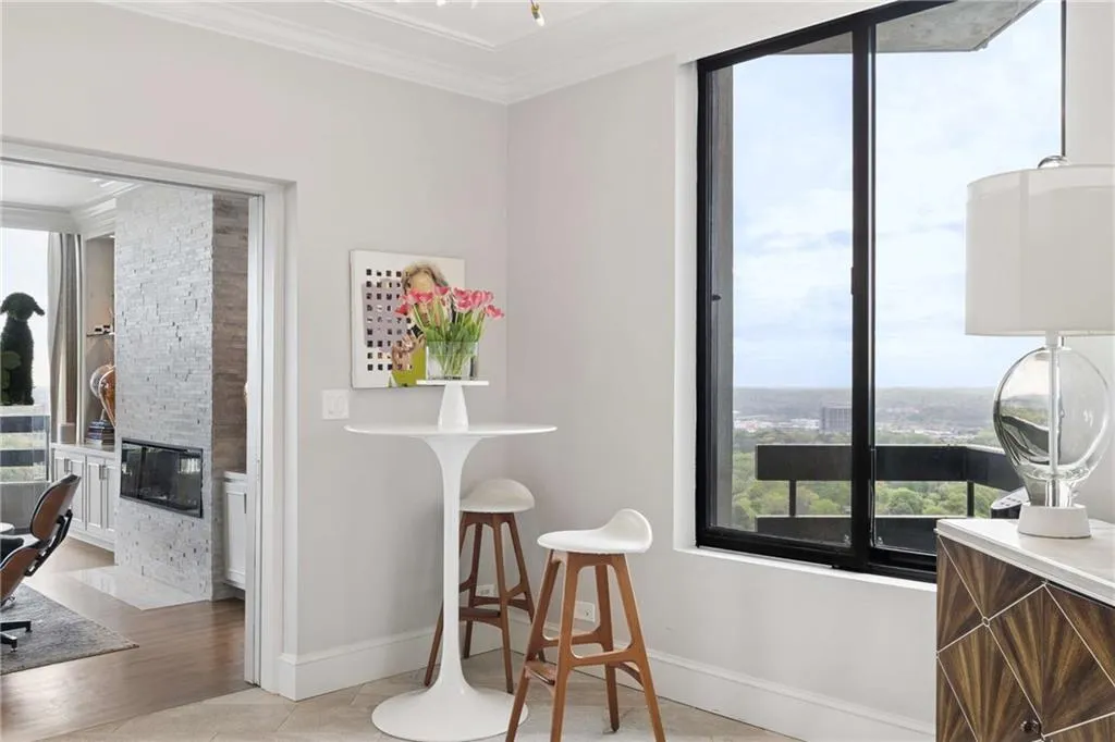 Dining room featuring a fireplace, crown molding, and light tile patterned floors