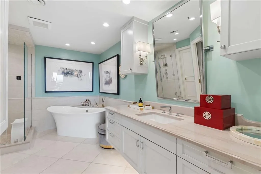 Bathroom with a shower stall, vanity, a soaking tub, recessed lighting, and light tile patterned floors