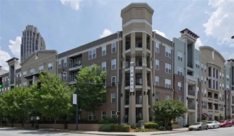 Multi-story building featuring brick and stucco siding with multiple balconies