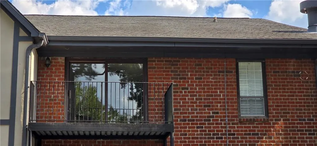 View of property exterior featuring a balcony