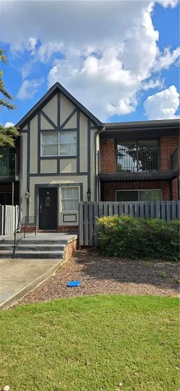 Back of property featuring a lawn