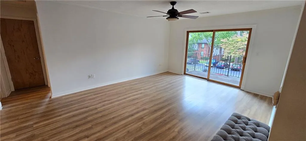 Empty room featuring hardwood / wood-style floors and ceiling fan