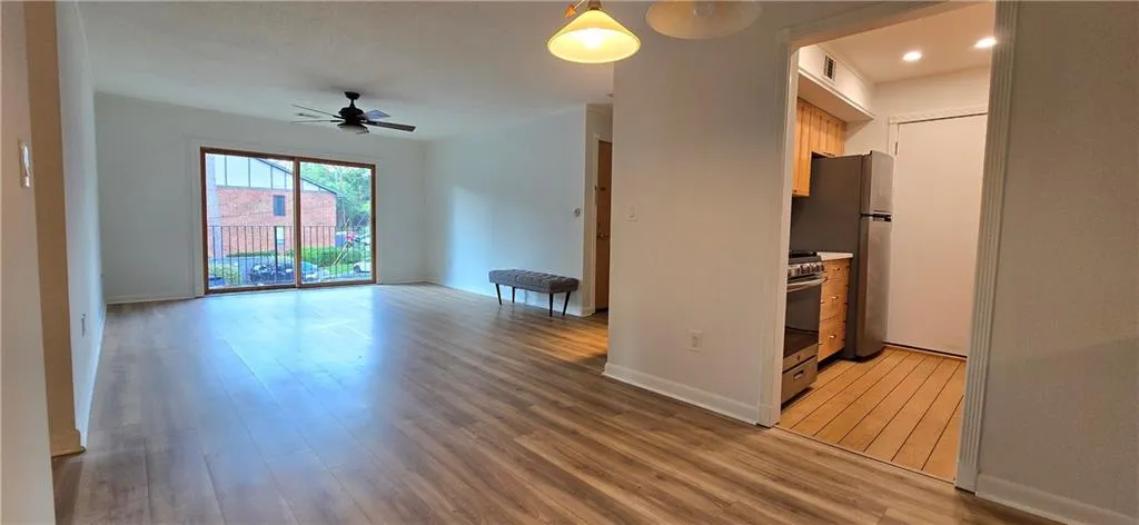 Kitchen featuring ceiling fan, stainless steel appliances, and hardwood / wood-style floors