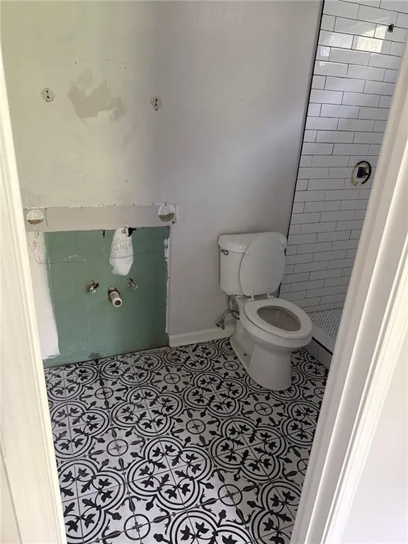Bathroom featuring tile patterned flooring and a shower stall