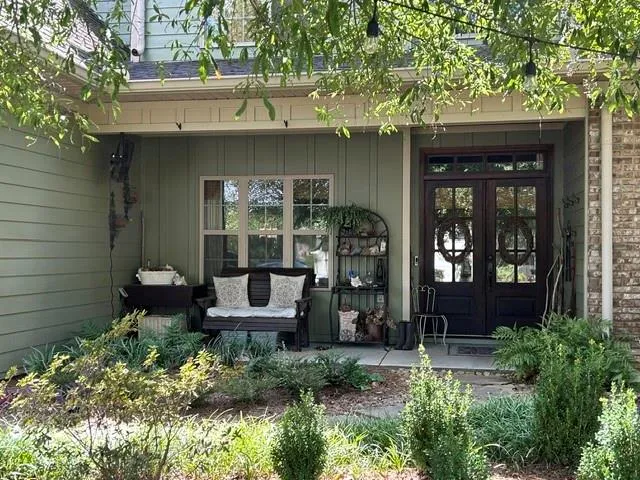 Brick and siding exterior with a covered porch