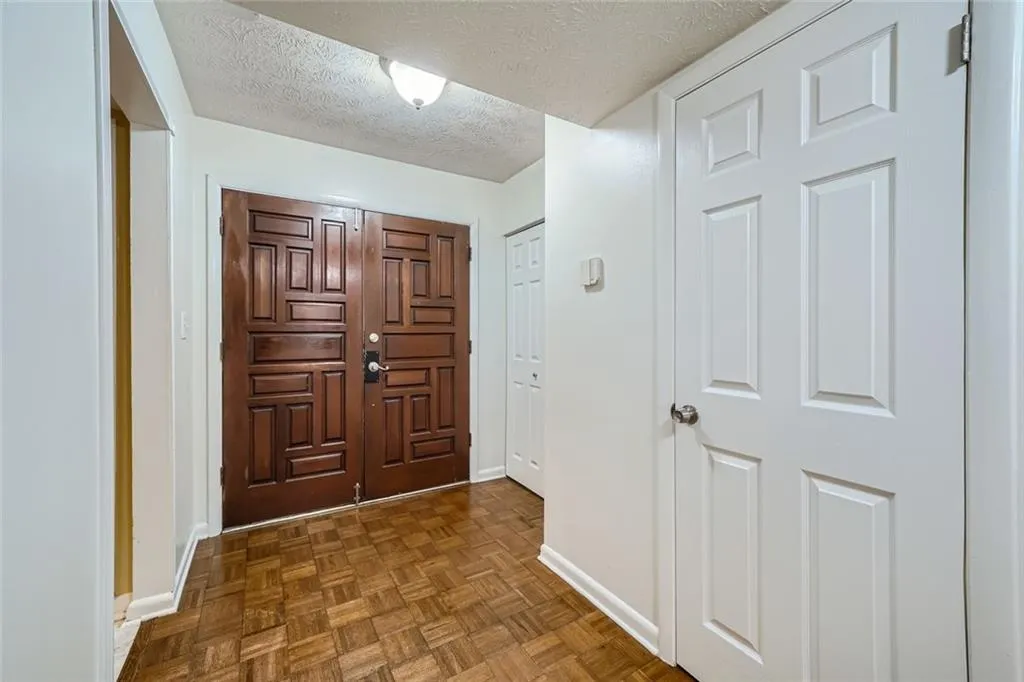 Entryway with a textured ceiling and parquet floors