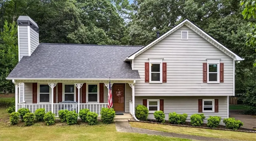 Two-story residence featuring light gray siding with red shutters