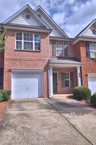 Brick exterior with white siding accents and a covered entry