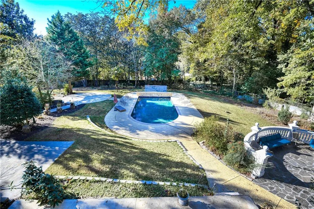 View of swimming pool with a fenced backyard, a fenced in pool, a patio, and a yard