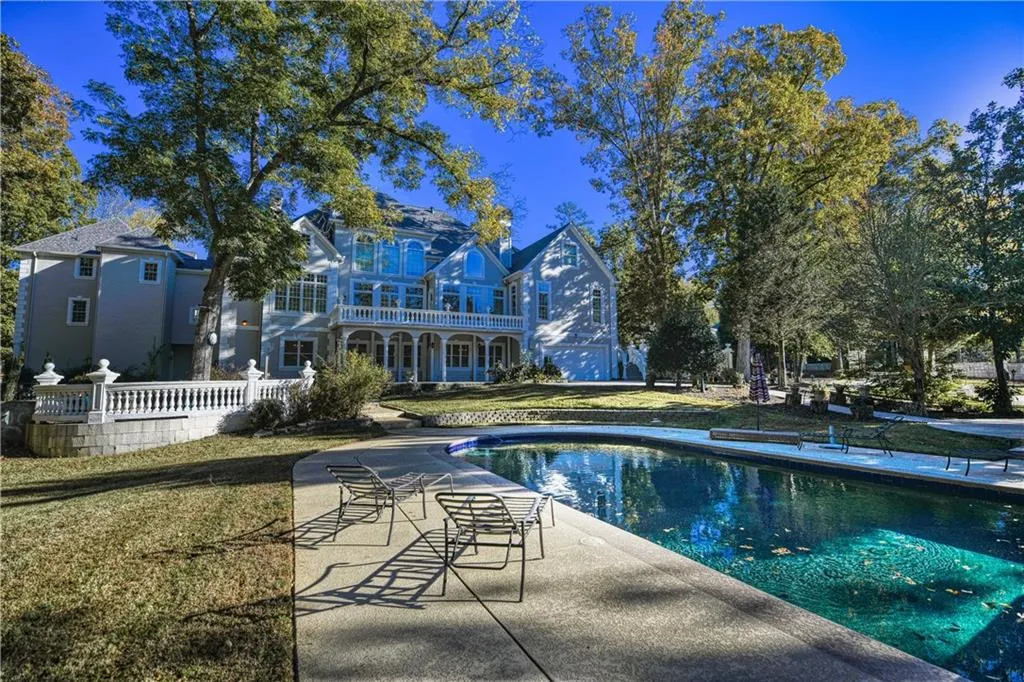 Pool featuring fence and a patio area