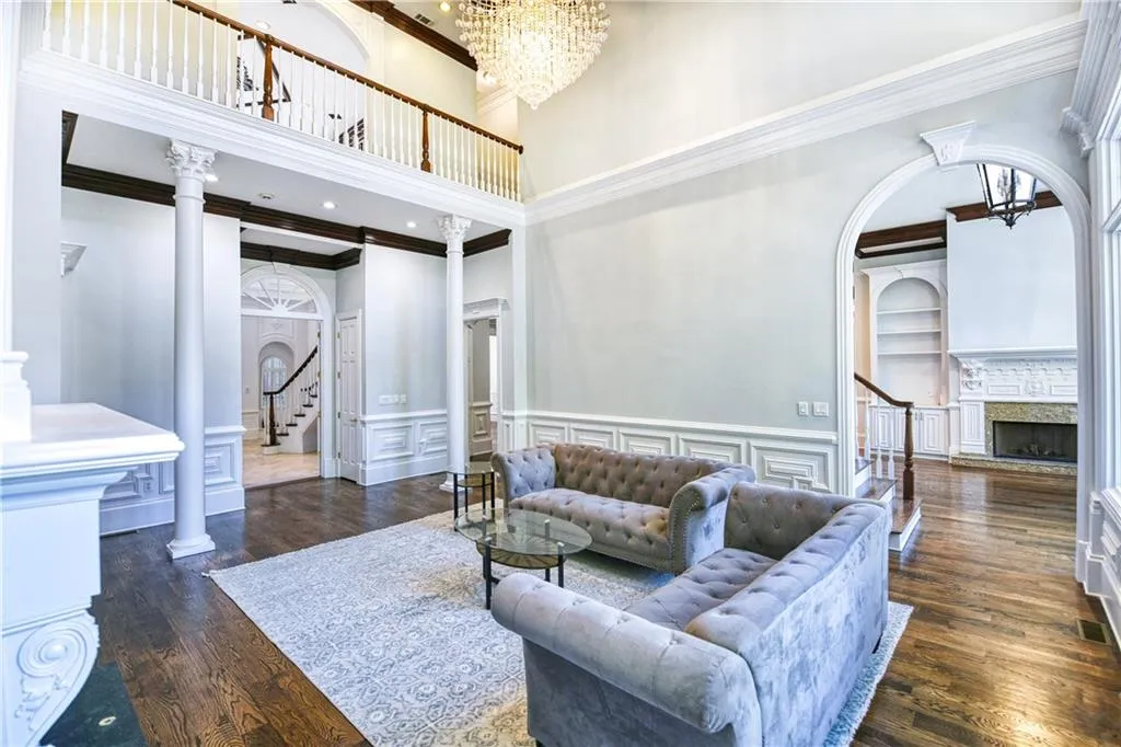 Living area featuring a chandelier, stairway, and built in shelves