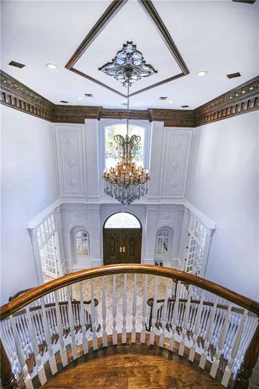 Stairway with visible vents, recessed lighting, and a notable chandelier