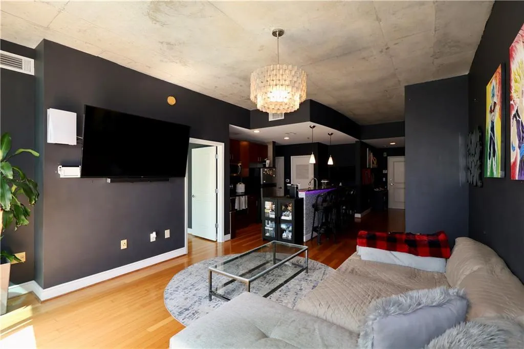 Living room with wood finished floors and a chandelier