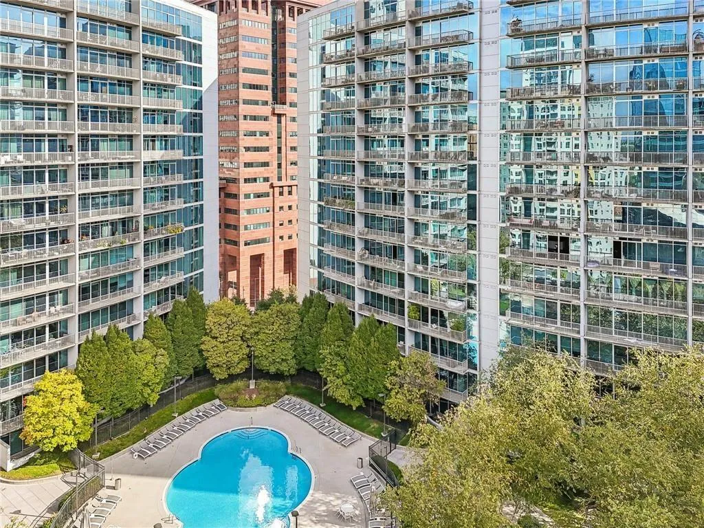 View of apartment building / complex with a community pool and a view of city