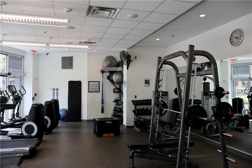 Exercise room featuring healthy amount of natural light and a paneled ceiling