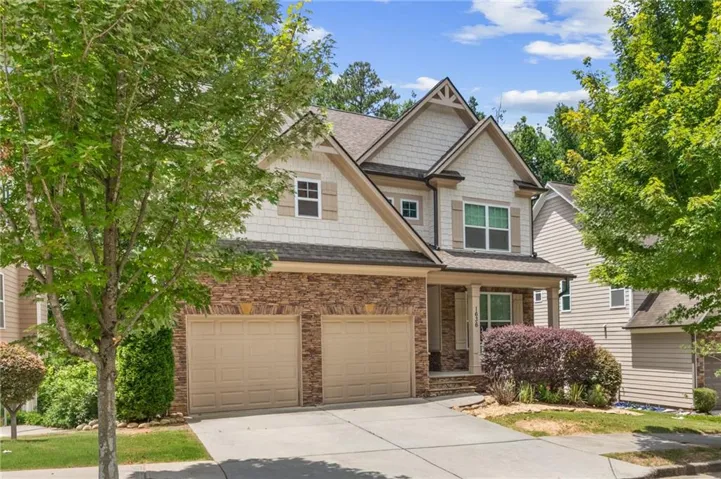 Craftsman-style facade featuring stacked stone accents and shake siding