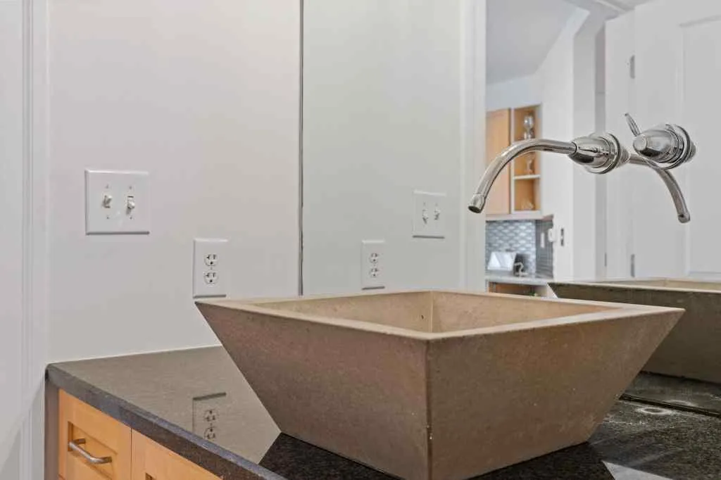 The second full bath has a single sink with extra counter space, and a tile shower with a glass enclosure.