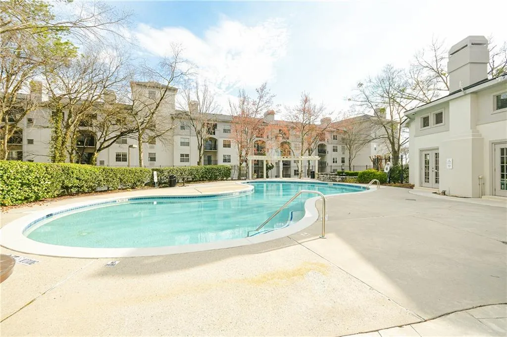 Community pool with a patio area and french doors