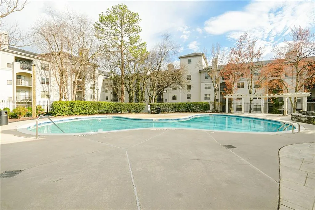 Pool with fence and a patio area