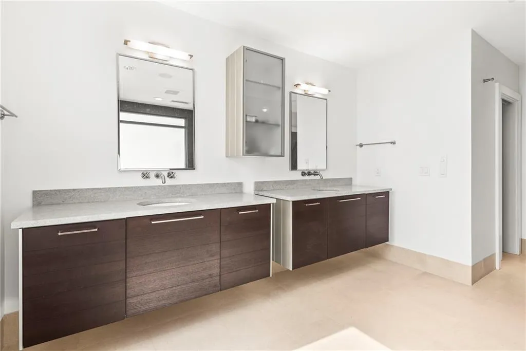 Modern lifted vanities & walk in closet on the right