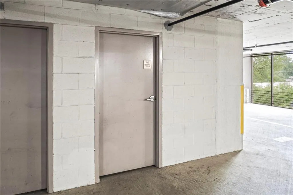 Enclosed storage space adjacent to parking in garage.
