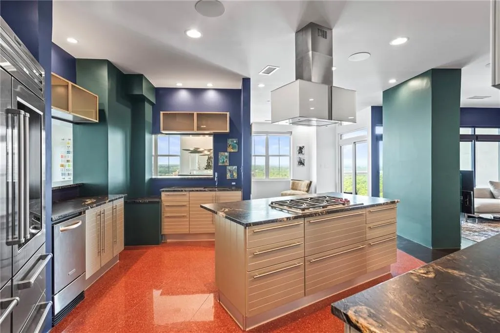 Beautiful stone counter tops and stone floor adds modern flair to this designer kitchen