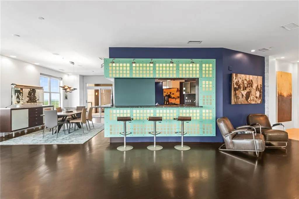 Custom design backlit dividing walls provide bar space for entertaining your guests