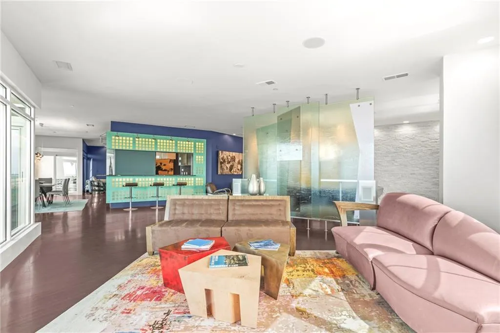 Custom designed back-lit wall separates the kitchen from the formal living space!